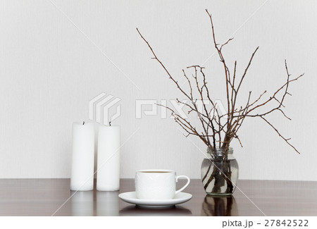 Cup candles and branches, grey and white stilllife Cup candles and branches, grey and white stilllife 27842522