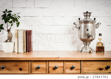 shelf with a book and a flower and a kettle 27847701