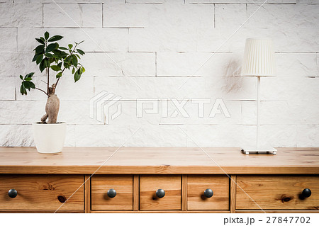 shelf with lamp and flower and white wall 27847702