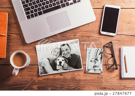 Office desk. Objects and black-and-white photos of 27847977