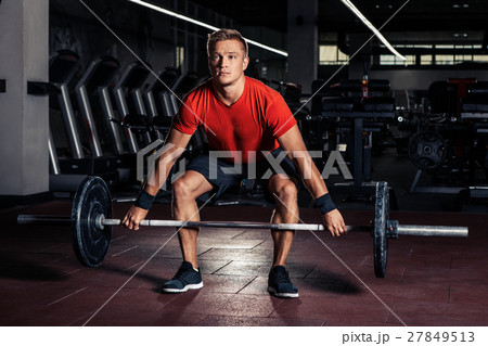 Young man at a crossfit gym Young man at a crossfit gym 27849513