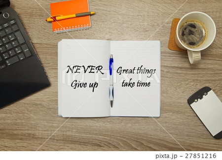 Open notebook with text "Never Give Up" 27851216