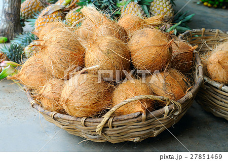 Coconuts in the basket in a vegetable shop 27851469