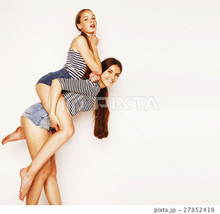 two cute teenagers having fun together isolated on two cute teenagers having fun together isolated on 27852419