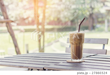 Ice coffee on a wooden table Ice coffee on a wooden table 27860324