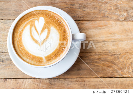 Cup of coffee latte art on wood table 27860422