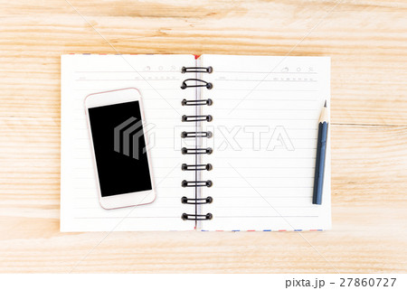 Open Notebook and smart phone on wood table for background 27860727