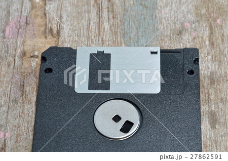 diskette on wooden board 27862591