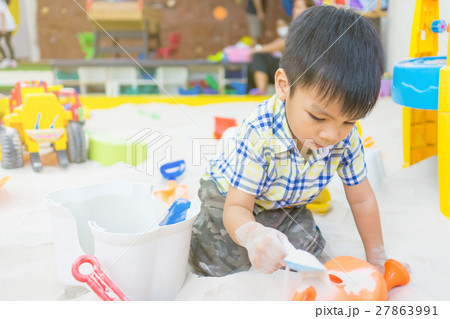 Boy is playing with sandbox toys Boy is playing with sandbox toys 27863991