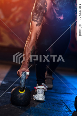 Sporty muscular man with kettle bell in gym Sporty muscular man with kettle bell in gym 27866303