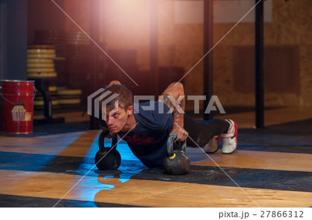 Strong adult exercising with kettle bell in gym 27866312