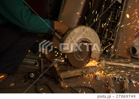 Worker use Electric grinder cutting metal Worker use Electric grinder cutting metal 27869749