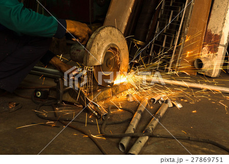 Worker use Electric grinder cutting metal 27869751