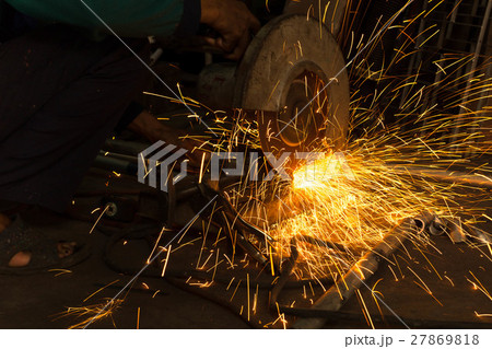 Worker use Electric grinder cutting metal 27869818