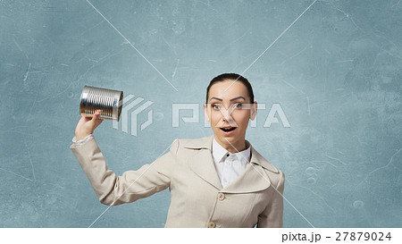 Woman using deaf phone Woman using deaf phone 27879024