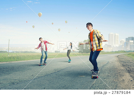 Teenagers ride skateboard 27879184