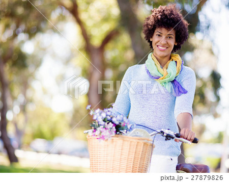 Happy young woman with bicycle 27879826