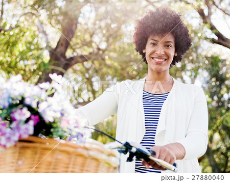 Happy young woman with bicycle Happy young woman with bicycle 27880040
