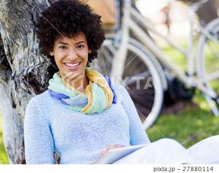 Young woman using tablet in the park. 27880114