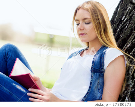 Beautiful young woman writing in her diary outdoors Beautiful young woman writing in her diary outdoors 27880272