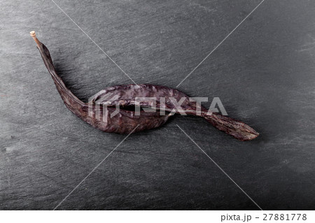 Carob on a stone plate Carob on a stone plate 27881778