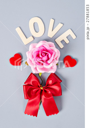 Pink rose and love word with red bow. Pink rose and love word with red bow. 27881853