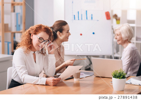 Involved businesswomen discussing the project at 27891438