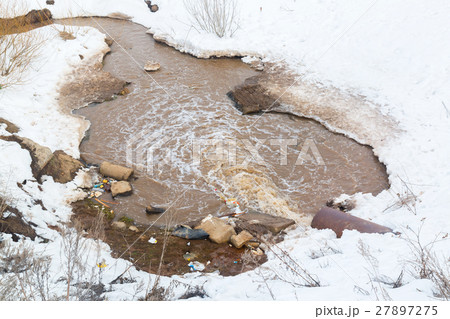Wastewater pollutes the environment. Dirty puddle. Wastewater pollutes the environment. Dirty puddle. 27897275