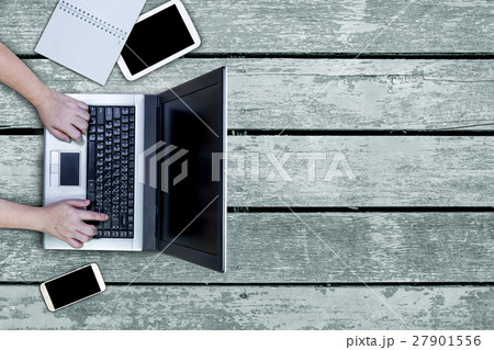 woman using laptop on desk 27901556