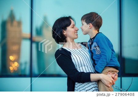 Loving mother and son hugging outdoors 27906408