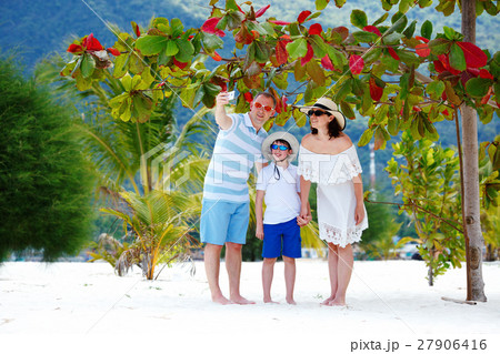 Beautiful family at beach making a self portrait 27906416