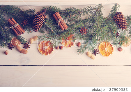Christmas background with Christmas tree branches, pine cones, d 27909388