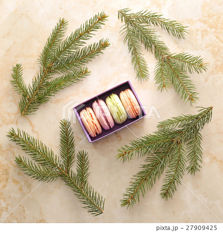 cake macarons in a purple box with the branches of a Christmas t cake macarons in a purple box with the branches of a Christmas t 27909425
