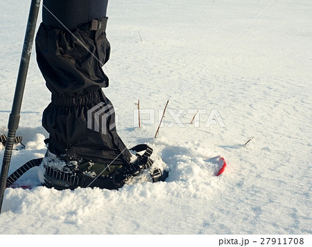 Man legs with snowshoes walk.Detail of winter hike Man legs with snowshoes walk.Detail of winter hike 27911708