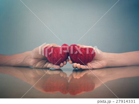Hands holding red hearts Hands holding red hearts 27914331