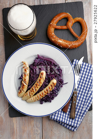 Grilled sausages with braised cabbage, beer, and pretzel Grilled sausages with braised cabbage, beer, and pretzel 27925622