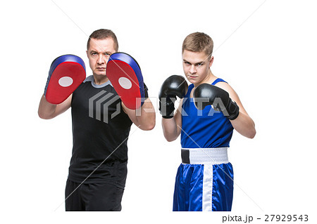 Young boxer working out with coach Young boxer working out with coach 27929543