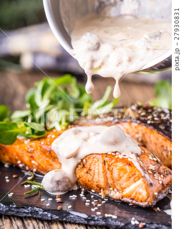 Grilled salmon, sesame seeds herb decoration. Grilled salmon, sesame seeds herb decoration. 27930831