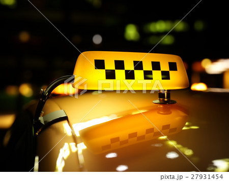 Yellow taxi sign checker at night 27931454