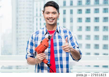 Young indonesian man with power drill 27931823