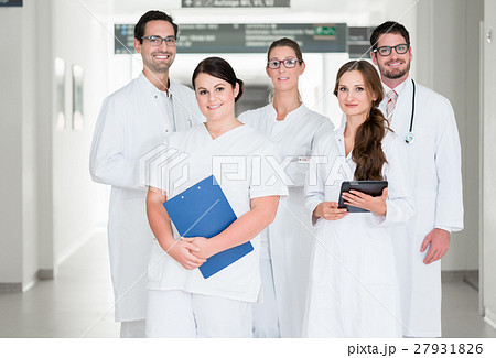 Team of doctors standing in hospital corridor Team of doctors standing in hospital corridor 27931826