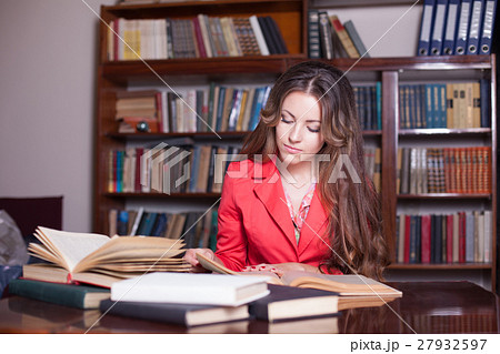 girl is preparing for the exam in the library 27932597