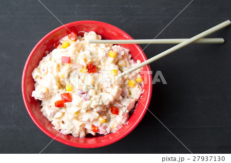 russian salad in a red bowl with chopsticks 27937130
