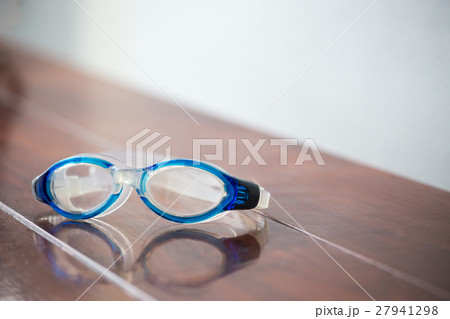 swimming goggle isolated on brown wood chair swimming goggle isolated on brown wood chair 27941298