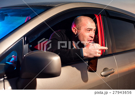 Drunk driver with beer bottle showing fuck gesture Drunk driver with beer bottle showing fuck gesture 27943656