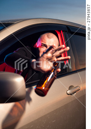 Driver covering his face from police car lighting Driver covering his face from police car lighting 27943657