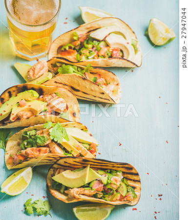 Corn chicken and avocado tortillas, beer in glass 27947044