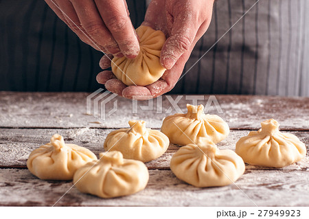 Cook preparing khinkali at kitchen close-up Cook preparing khinkali at kitchen close-up 27949923