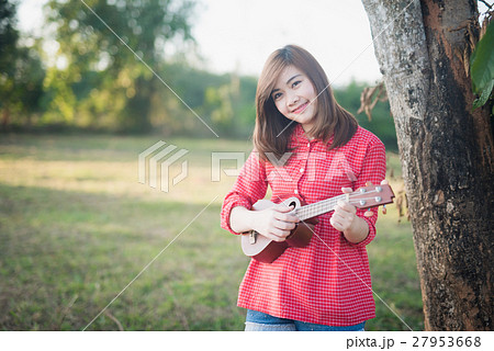 girl playing ukulele at garden 27953668