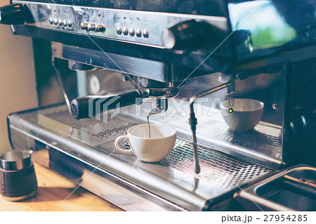 Barista using coffee machine preparing coffee Barista using coffee machine preparing coffee 27954285